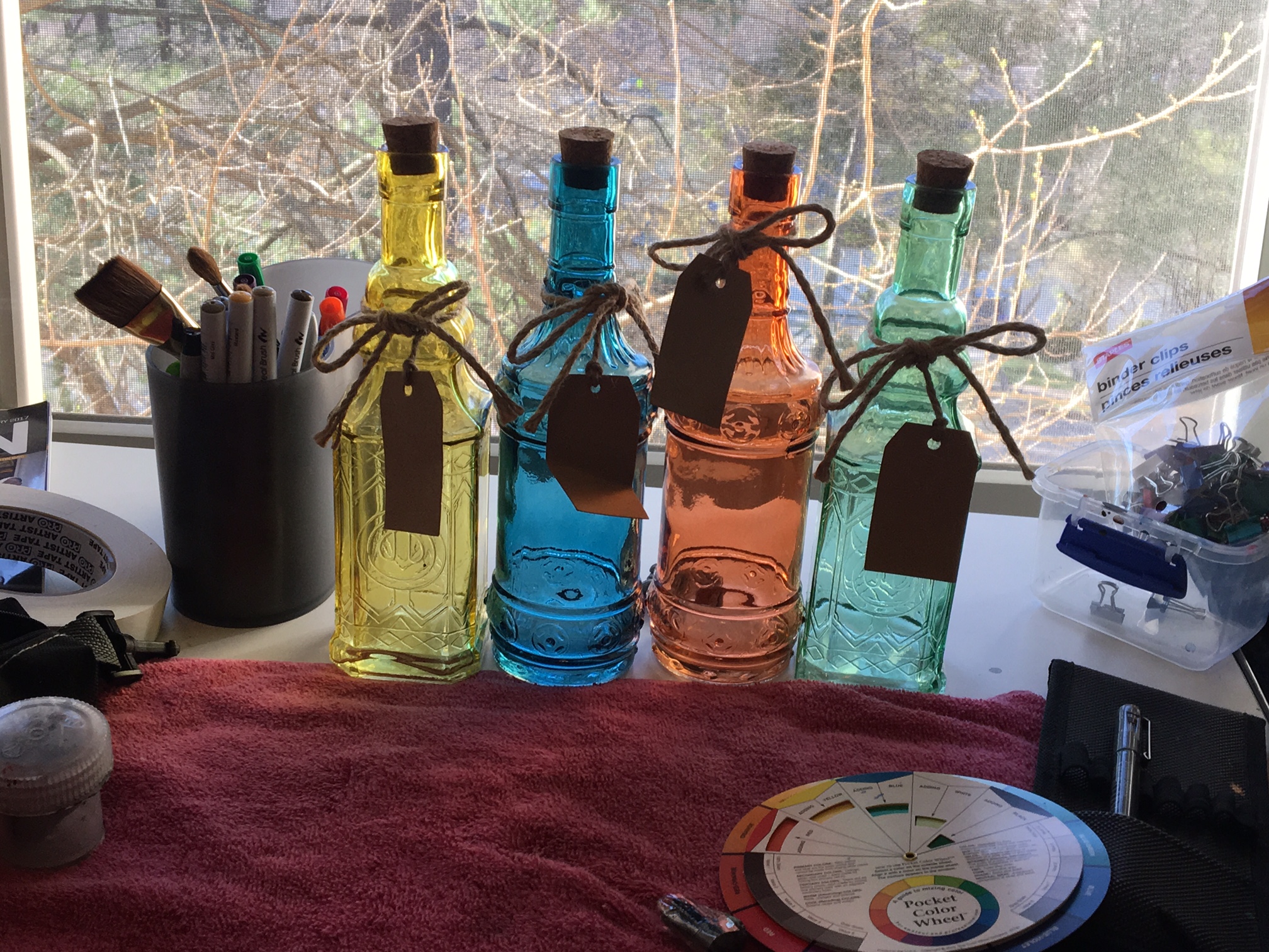 Colored bottles in a window photo